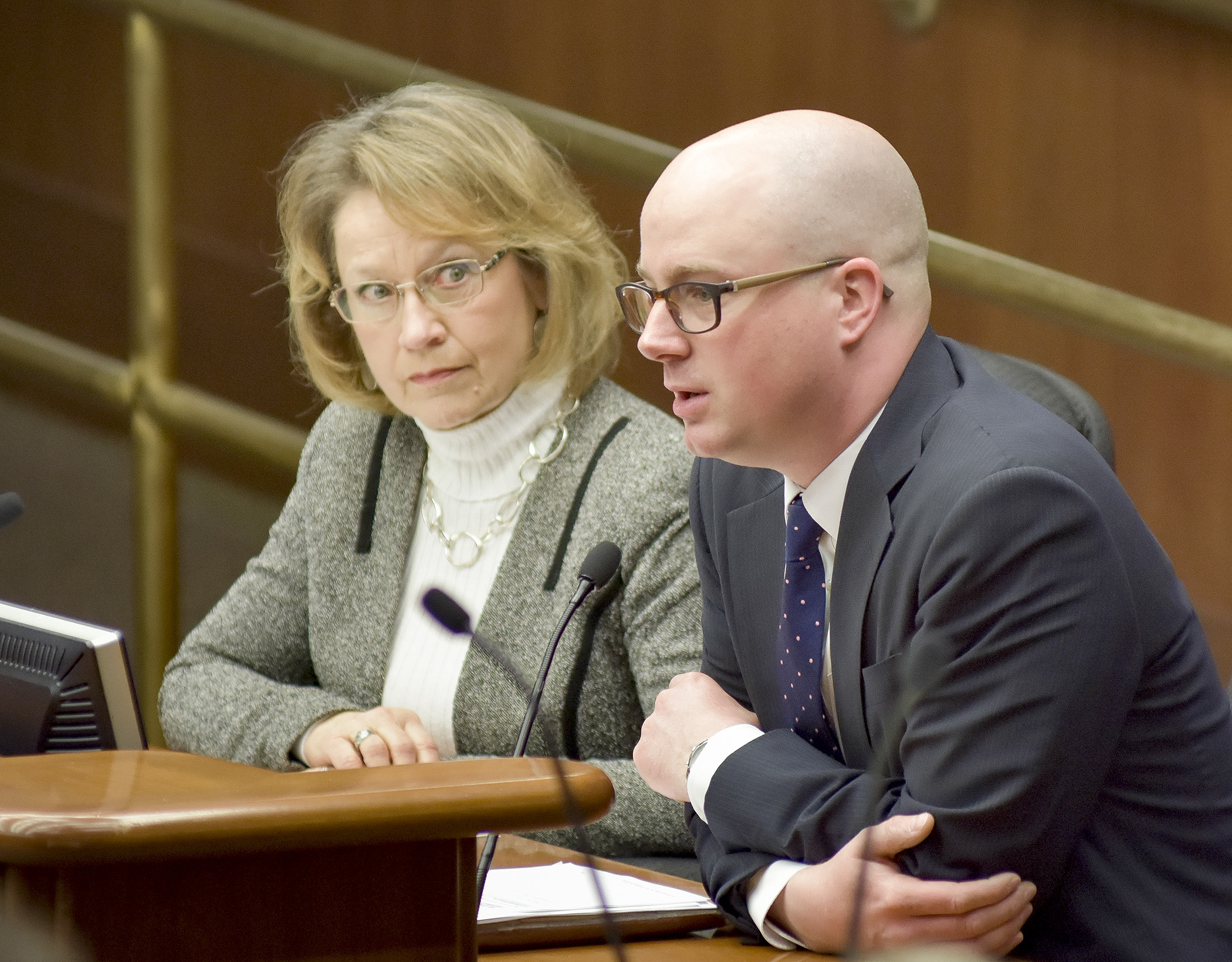 Bentley Graves of the Minnesota Chamber of Commerce, testifies before the House Transportation and Regional Governance Policy Committee Feb. 27 in support of a bill sponsored by Rep. Linda Runbeck, left. Photo by Andrew VonBank